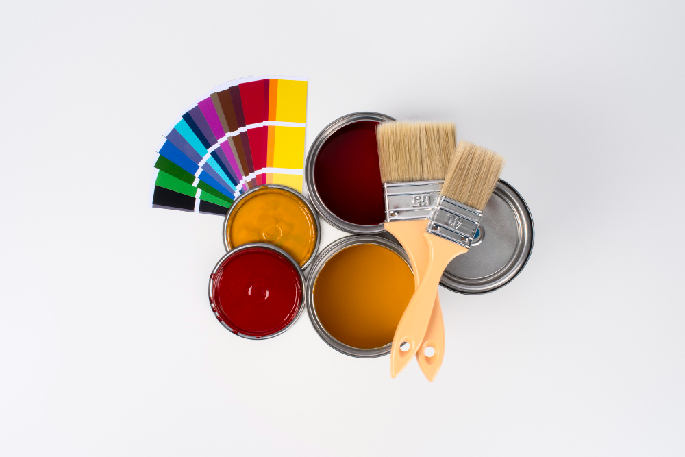 Premium interior home colours palette with paint cans and brushes showcasing best interior emulsions paints in Kerala